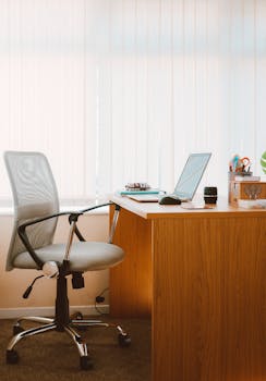 pexels photo 1957477 1957477 A tranquil modern home office featuring a wooden desk, ergonomic chair, and soft natural light.