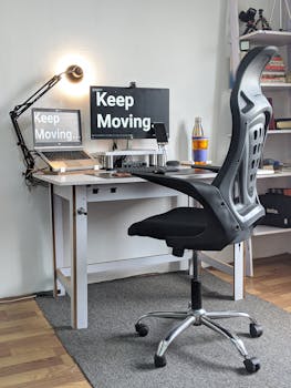 pexels photo 4930018 4930018 Stylish home office with ergonomic chair, desk, laptop, and motivational screens.